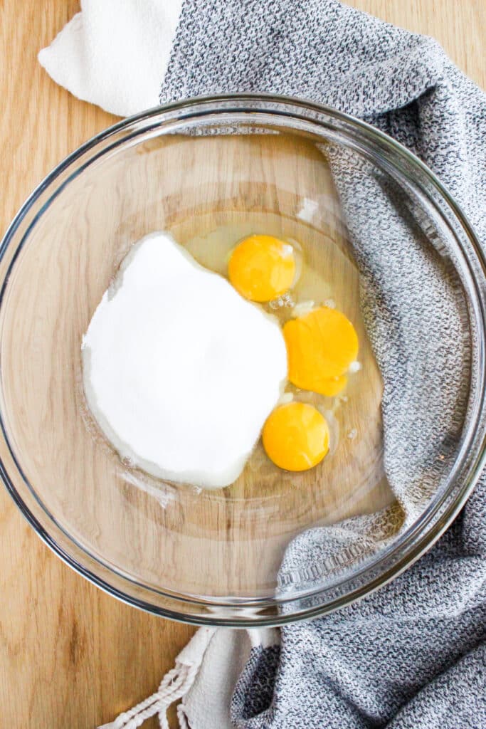 Eggs and sugar in a bowl for Hot Milk Vanilla Sponge Cake