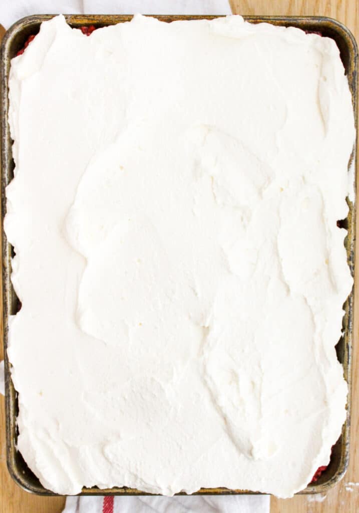 whipped cream on lemon raspberry sheet cake
