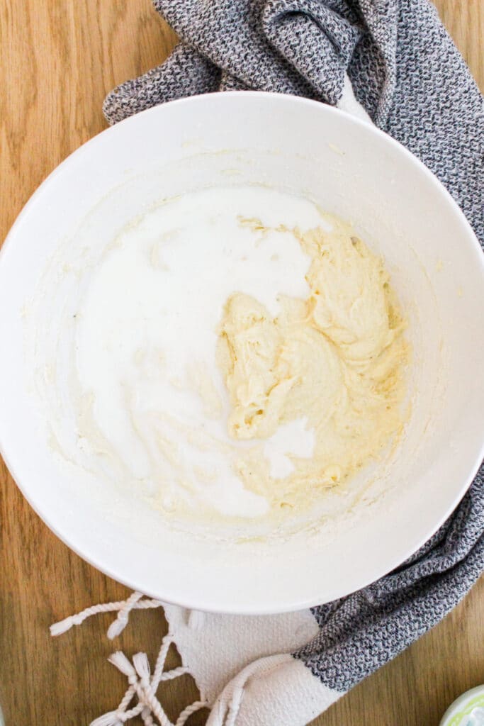 adding milk to batter for pistachio pound cake
